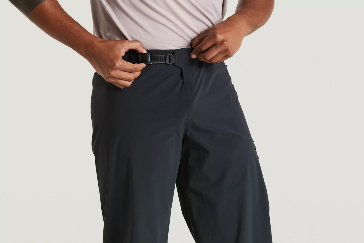 Vista de la cintura y sistema de ajuste del pantalon corto de trail marca Specialized para hombre de color negro, diseño y estilo premium