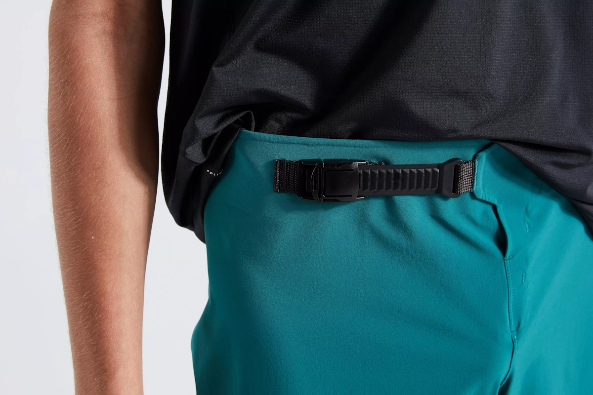 Vista del sistema de cierre del Pantalon corto de trail marca Specialized para hombre de color Green Teal, diseño y estilo premium